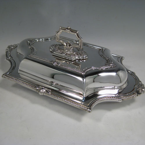 Antique Victorian silver-plated pair of entree dishes with covers, having bayonet-fit removable handles, very pretty shaped rectangular bodies, with gadroon and floral borders. Made by James Dixon and Sons in ca. 1870. Length 36 cms (14 inches), height including handle 13 cms (5 inches), width 22 cms (8.5 inches).