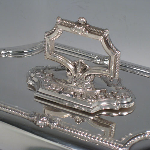 Antique Victorian silver-plated pair of entree dishes with covers, having bayonet-fit removable handles, very pretty shaped rectangular bodies, with gadroon and floral borders. Made by James Dixon and Sons in ca. 1870. Length 36 cms (14 inches), height including handle 13 cms (5 inches), width 22 cms (8.5 inches).