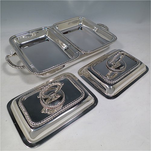 An Antique Edwardian Sterling Silver pair of entrï¿½e dishes with covers on a silver-plated warming stand for hot water, having rectangular bodies with applied gadroon borders, and with removable bayonet-fit handles. All in original condition and made by Goldsmiths & Silversmiths of London in 1902. The dimensions of this fine pair of hand-made antique silver entree dishes on a silver plated warming stand are length (inc. handles) 34 cms (13.5 inches), width 20 cms (8 inches), height 12 cms (5 inches), and the entree dishes weigh approx. 1,721g (55.5 troy ounces).   