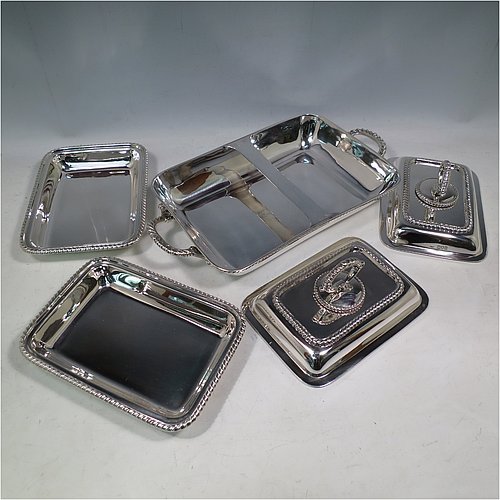 An Antique Edwardian Sterling Silver pair of entrï¿½e dishes with covers on a silver-plated warming stand for hot water, having rectangular bodies with applied gadroon borders, and with removable bayonet-fit handles. All in original condition and made by Goldsmiths & Silversmiths of London in 1902. The dimensions of this fine pair of hand-made antique silver entree dishes on a silver plated warming stand are length (inc. handles) 34 cms (13.5 inches), width 20 cms (8 inches), height 12 cms (5 inches), and the entree dishes weigh approx. 1,721g (55.5 troy ounces).   