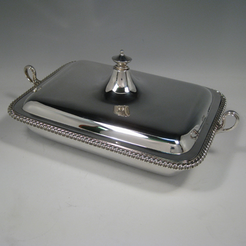    Antique Victorian sterling silver two-handled entree dish with cover and internal liner with space underneath to pour hot water. Made by Turner Bradbury of Sheffield in 1900. Length (inc. handles) 35 cms (13.75 inches), width 21.5 cms (8.5 inches), height (inc. finial) 14 cms (5.5 inches). Weight approx. 56 troy ounces (1,736g).