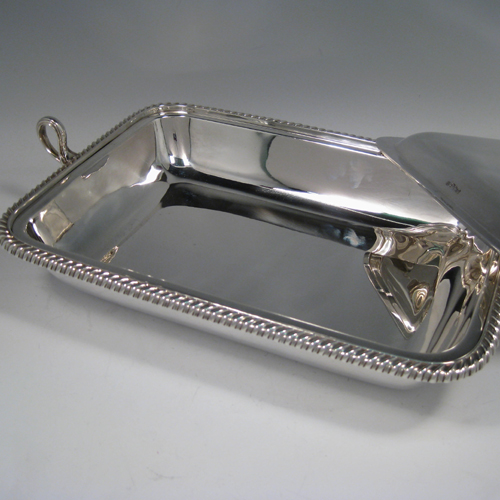    Antique Victorian sterling silver two-handled entree dish with cover and internal liner with space underneath to pour hot water. Made by Turner Bradbury of Sheffield in 1900. Length (inc. handles) 35 cms (13.75 inches), width 21.5 cms (8.5 inches), height (inc. finial) 14 cms (5.5 inches). Weight approx. 56 troy ounces (1,736g).