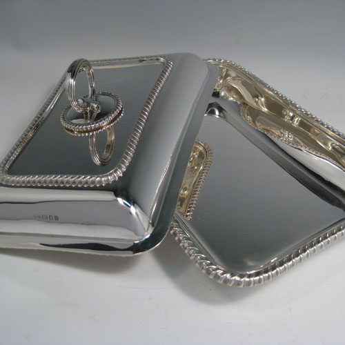    Sterling silver pair of heavy entree dishes and covers, with removable bayonet-fit handles, and gadroon edges. Made by the Crighton Brothers of London in 1929/30. Length 28.5 cms (11.25 inches), width 20 cms (8 inches), height inc. handle 11 cms (4.25 inches). Total weight approx. 102 troy ounces (3,162g).