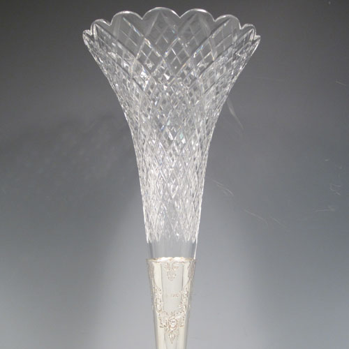 Antique Victorian sterling silver epergne flower vase centerpiece, having a central flower vase with hand-cut crystal holder, a hand-chased dish surrounding the latter with fruit and floral decoration, all sitting on a pedestal foot with matching hand-chased work. Made by Martin and Hall of London in 1881. The dimensions of this fine hand-made silver center-piece are height 47 cms (18.5 cms), diameter 23.5 cms (9.25 inches), and it weighs approx. 788g (25.3 troy ounces).