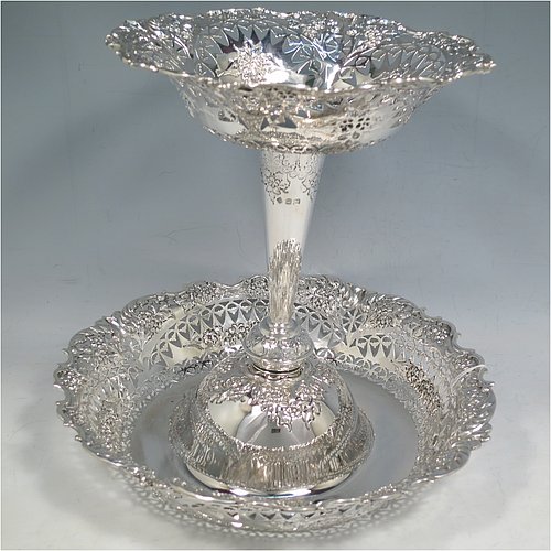 An Antique Victorian Sterling Silver epergne centerpiece, having a central upper dish attached to a larger lower dish, with hand-cut and hand-chased floral and fruit decoration, all sitting on a flat base. Made by Martin and Hall of Sheffield in 1896. The dimensions of this fine hand-made antique silver centre-piece are height 23 cms (9 inches), diameter at base 25 cms (9.75 inches), and it weighs approx. 713g (23 troy ounces).   