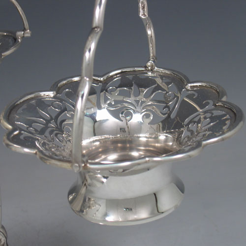    Antique Edwardian sterling silver pierced basket epergne with central vase and three removable pierced baskets. Made by Elkington & Co., of London in 1906. Height 33 cms, spread 30 cms. Weight approx. 43 troy ounces.