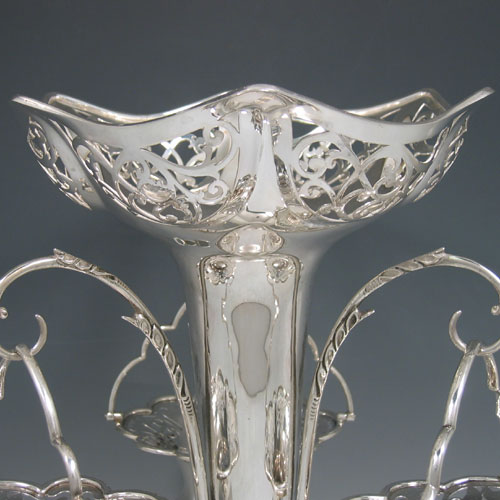    Antique Edwardian sterling silver pierced basket epergne with central vase and three removable pierced baskets. Made by Elkington & Co., of London in 1906. Height 33 cms, spread 30 cms. Weight approx. 43 troy ounces.