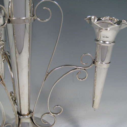    Sterling silver flower vase epergne with one large central vase and three smaller side vases. All vases are removable. Made by Walker and Hall of Sheffield in 1918. Height 35.5 cms (14 inches), spread across arms 33 cms (13 inches). 