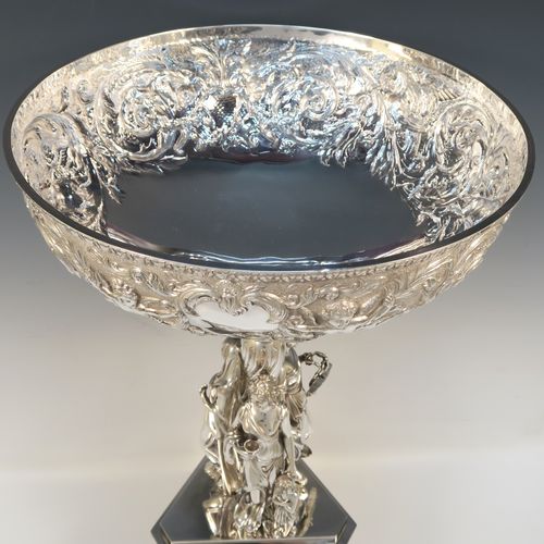 A beautiful and impressive Scottish Antique Victorian Sterling Silver epergne centre-piece, having a top bowl with hand-chased floral, scroll and figural decoration, above a central area consisting of three separate cast caryatid female figures, all sitting on a triangular plinth with tapering sides and applied figural and scroll motifs. This wonderful antique silver centrepiece epergne was made by Marshall and Sons of Edinburgh, Scotland, in 1837. The dimensions of this fine hand-made silver centre-piece are height 47.5 cms (18.75 cms), diameter of bowl 28 cms (11 inches), and it weighs approx. 3,680g (118.7 troy ounces).   