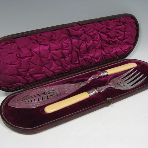    Antique Victorian sterling silver and bone-handled fish server set in original purple velvet and satin-lined presentation box, with hand-engraved floral decoration and hand-pierced blade and tines. Made by John Newman of Sheffield in 1882. Length of knife 32.5 (12.75 inches), length of fork 24 cms (9.5 inches).