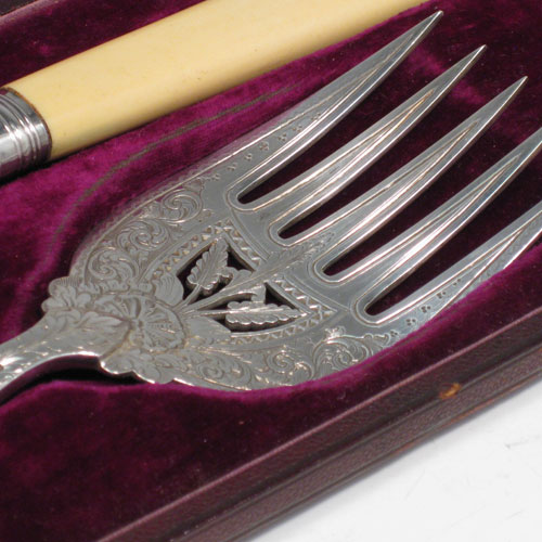    Antique Victorian sterling silver and bone-handled fish server set in original purple velvet and satin-lined presentation box, with hand-engraved floral decoration and hand-pierced blade and tines. Made by John Newman of Sheffield in 1882. Length of knife 32.5 (12.75 inches), length of fork 24 cms (9.5 inches).