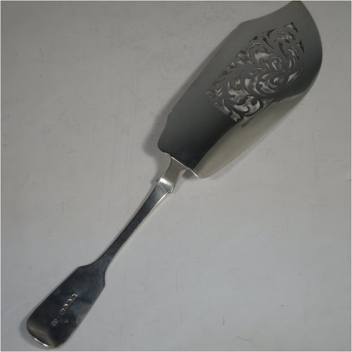 Antique Georgian sterling silver fish server slice, having a plain Fiddle pattern handle, a hand-pierced asymmetrical and curved blade, and a hand-engraved reeded border. Made by William Eley of London in 1838. The dimensions of this fine hand-made silver fish serving slice are length 30 cms (11.75 inches), and it weighs approx. 140g (4.5 troy ounces).   