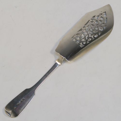 A very handsome Antique Victorian Sterling Silver fish server slice, in the Fiddle pattern, with a hand-pierced asymmetrical and curved blade. This elegant antique silver fish serving slice was made by George Adams London in 1845. The dimensions of this fine hand-made antique silver fish server are length 32 cms (12.5 inches), and it weighs approx. 173g (5.6 troy ounces). Please note that this item is crested on the handle.