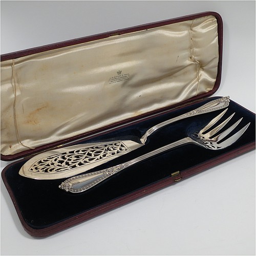 An Antique Victorian Sterling Silver pair of fish serving knife and fork set, having solid handles in the double-struck Victorian Bead pattern, with reeded handles, and hand-pierced blade and tines with floral decoration, all in their original blue velvet and cream satin lined presentation box. Made by George Adams of London in 1862. The dimensions of this fine hand-made antique silver fish serving set are length of knife 31 cms (12.75 inches), length of fork 25.5 cms (10 inches), and they weigh a total of 320g (10.3 troy ounces).   