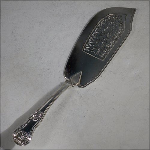 An Antique Georgian Sterling Silver fish server slice, having a double-struck Kings pattern handle, a hand-pierced asymmetrical and curved blade, and a hand-engraved reeded border. Made by William Knight of London in 1821. The dimensions of this fine hand-made antique silver fish serving slice are length 30 cms (11.75 inches), and it weighs approx. 154g (5 troy ounces).    