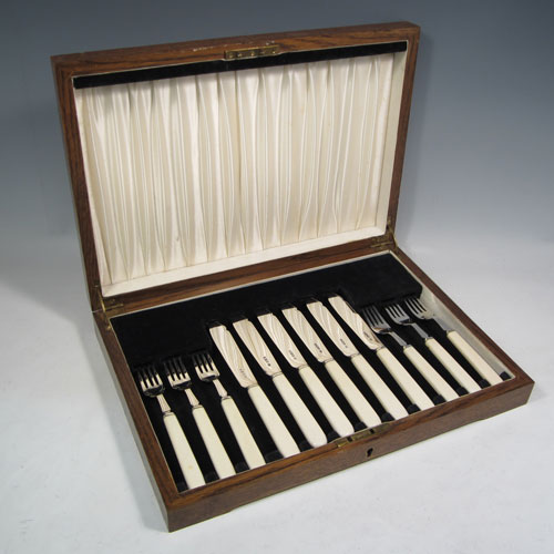 Sterling silver and bone-handled fish set for six people, having plain blades and tines with a hand-chased thread, and fitted into their original velvet and satin-lined oak presentation box. All made in Sheffield in 1942. The dimensions of these fine hand-made silver fish-eaters are length of knife 19 cms (7.5 inches), and fork 16 cms (6.25 inches). 