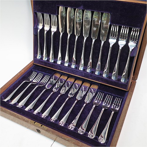 A very handsome Antique Edwardian Sterling Silver fish service set for twelve people, in the plain Hanoverian pattern, with four-prong forks and flat symmetrical bladed knives, fitted into their original dark blue velvet-lined oak presentation box. All made by Mappin and Webb of Sheffield in 1909. The dimensions of these fine hand-made antique silver fish-eaters are length of knife 20 cms (8 inches), and fork 17 cms (6.75 inches), with a total weight of approx. 1,310g (42 troy ounces). Please note that the small brass plaque on top of the boxes lid is missing.    