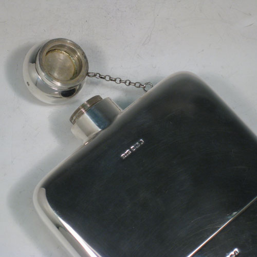 Sterling silver very large whisky hip flask, having a plain rectangular body with rounded shoulders, a screw-top fit lid with security chain, and a pull-off cup. Made by James Dixon of Sheffield in 1921. The dimensions of this fine hand-made silver whisky flask are length 23 cms (9 inches), width 14 cms (5.5 inches), depth 4 cms (1.5 inches) and it weighs approx. 878g (28 troy ounces).    