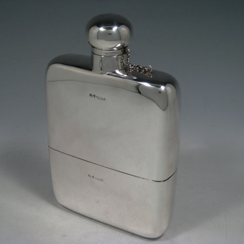 Sterling silver very large whisky hip flask, having a plain rectangular body with rounded shoulders, a screw-top fit lid with security chain, and a pull-off cup. Made by James Dixon of Sheffield in 1921. The dimensions of this fine hand-made silver whisky flask are length 23 cms (9 inches), width 14 cms (5.5 inches), depth 4 cms (1.5 inches) and it weighs approx. 878g (28 troy ounces).    