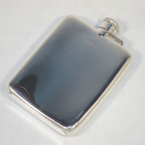 A handsome Sterling Silver whisky hip flask, having a plain shaped rectangular body with rounded shoulders, and a bayonet-fit lid with knurled edge. This elegant silver whisky flask was made by Henry Atkins of Sheffield in 1946. The dimensions of this fine hand-made silver hip whisky flask are length 15 cms (6 inches), width 10 cms (4 inches), depth 2 cms (0.75 inch), and it weighs approx. 215g (7 troy ounces).  