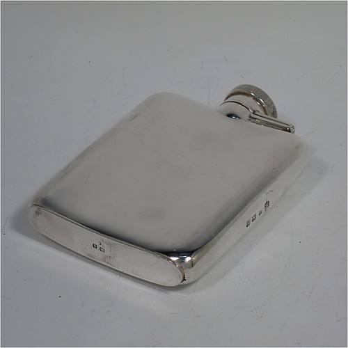 A Sterling Silver whisky hip flask, having a plain shaped rectangular body with rounded shoulders, and a hinged bayonet-fit lid with knurled thumb-piece. Made by William Neale of Birmingham in 1942. The dimensions of this fine hand-made silver whisky flask are length 10 cms (4 inches), width 7 cms (2.75 inches), depth 2 cms (0.75 inches) and it weighs approx. 108g (3.5 troy ounces).   