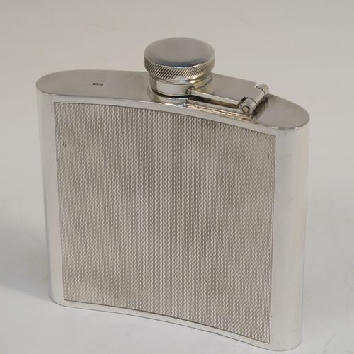 A handsome Sterling Silver whisky flask, having a square curved body with rounded sides, a plain flat top and base, and a hinged and bayonet-fit lid with knurled top, and engraved with engine-turning. This elegant silver flask was made by Garrards and Co., of London in 1974. The dimensions of this fine hand-made silver whisky hip flask are height 10 cms (4 inches), width 10 cms (4 inches), depth 2 cms (0.75 inch), and it weighs approx. 217g (7 troy ounces).  