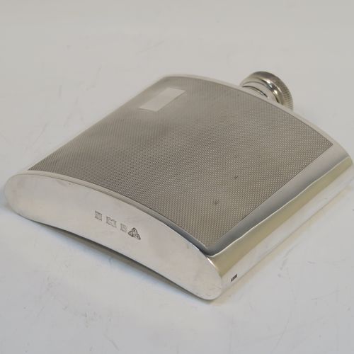 A handsome Sterling Silver whisky flask, having a square curved body with rounded sides, a plain flat top and base, and a hinged and bayonet-fit lid with knurled top, and engraved with engine-turning. This elegant silver flask was made by Garrards and Co., of London in 1974. The dimensions of this fine hand-made silver whisky hip flask are height 10 cms (4 inches), width 10 cms (4 inches), depth 2 cms (0.75 inch), and it weighs approx. 217g (7 troy ounces).  