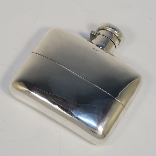 A heavy and very handsome Antique Sterling Silver whisky hip flask, having a plain shaped rectangular body with rounded shoulders, a bayonet-fit lid, and a pull-off cup with gold-gilt interior. This elegant antique silver whisky flask and cup were made by Deakin and Francis of Birmingham in 1917. The dimensions of this fine hand-made antique silver whisky flask are length 12 cms (4.75 inches), width 12 cms (4.75 inches), depth 4 cms (1.5 inches), and it weighs approx. 272g (8.8 troy ounces).   