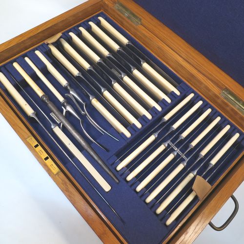 A very handsome and complete Antique Edwardian  Silver Plated Old English pattern flatware / cutlery service for twelve people in original oak canteen with brass fitting, having 101 pieces total including 12 table forks, 12 dessert forks, 12 table / soup spoons, 12 dessert spoons, 12 tea spoons, 6 egg spoons, 12 bone-handled table knives, 12 bone-handled dessert knives, a butter knife, a condiment spoon, a pair of sugar nips, a pair of sauce ladles, a large soup ladle, and a 5-piece bone-handled carving set. All made by Harrison Brothers and Howson of Sheffield in ca. 1910. 