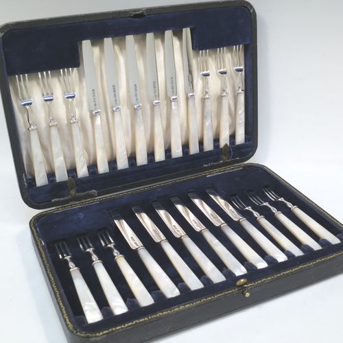 A very elegant Antique Sterling Silver and mother-of-pearl handled fruit set for twelve people. Having plain straight-sided pointed-end blade knives, and three-prong forks. All fitted into an original presentation box with cream satin and dark blue velvet interior. Made by James Dixon and Sons of Sheffield in 1925. The dimensions of this fine hand-made antique silver fruit service are length of knife 19 cms (7.5 inches), and the length of the fork 13.5 cms (5.25 inches).  