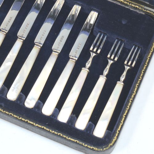 A very elegant Antique Sterling Silver and mother-of-pearl handled fruit set for twelve people. Having plain straight-sided pointed-end blade knives, and three-prong forks. All fitted into an original presentation box with cream satin and dark blue velvet interior. Made by James Dixon and Sons of Sheffield in 1925. The dimensions of this fine hand-made antique silver fruit service are length of knife 19 cms (7.5 inches), and the length of the fork 13.5 cms (5.25 inches).  