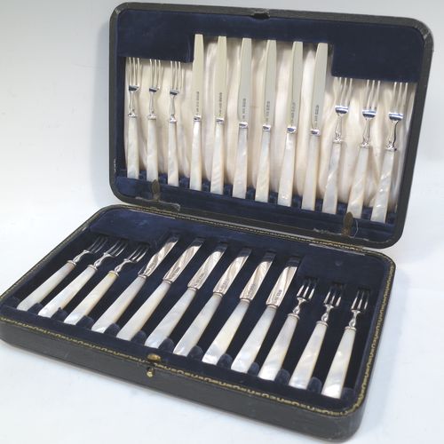 A very elegant Antique Sterling Silver and mother-of-pearl handled fruit set for twelve people. Having plain straight-sided pointed-end blade knives, and three-prong forks. All fitted into an original presentation box with cream satin and dark blue velvet interior. Made by James Dixon and Sons of Sheffield in 1925. The dimensions of this fine hand-made antique silver fruit service are length of knife 19 cms (7.5 inches), and the length of the fork 13.5 cms (5.25 inches).  