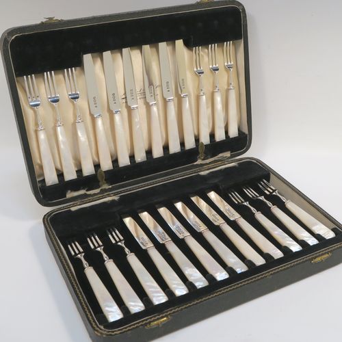 A very elegant Sterling Silver and mother-of-pearl handled fruit set for twelve people. Having plain straight-sided pointed-end blade knives, and three-prong forks. All fitted into an original presentation box with cream satin and black velvet-lined interior. This handsome silver and mother-of-pearl fruit eating set was made by Charles James Allen of Sheffield in 1935. The dimensions of this fine hand-made silver fruit service are length of knife 15 cms (6 inches), and the length of the fork 13.5 cms (5.3 inches).   