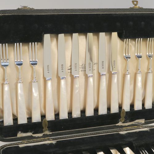 A very elegant Sterling Silver and mother-of-pearl handled fruit set for twelve people. Having plain straight-sided pointed-end blade knives, and three-prong forks. All fitted into an original presentation box with cream satin and black velvet-lined interior. This handsome silver and mother-of-pearl fruit eating set was made by Charles James Allen of Sheffield in 1935. The dimensions of this fine hand-made silver fruit service are length of knife 15 cms (6 inches), and the length of the fork 13.5 cms (5.3 inches).   