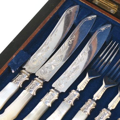 A beautiful Antique Victorian Sterling Silver and hand-carved mother-of-pearl handled fruit set for twelve people in its original dark blue velvet-lined and Walnut canteen box, with removable upper tray. The knives having slightly curved blades with silver ferrules and hand-engraved floral decoration. The forks having silver ferrules and four plain tines. This very pretty antique silver and mother-of-pearl fruit eating service was made by James Round of Sheffield over the period 1854 to 1865. The dimensions of this fine hand-made sterling silver and mother-of-pearl fruit set are length of knife 21 cms (8.25 inches), length of fork 18 cms (7 inches)   