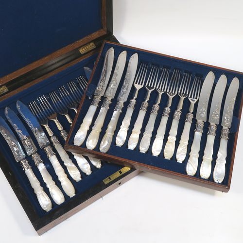 A beautiful Antique Victorian Sterling Silver and hand-carved mother-of-pearl handled fruit set for twelve people in its original dark blue velvet-lined and Walnut canteen box, with removable upper tray. The knives having slightly curved blades with silver ferrules and hand-engraved floral decoration. The forks having silver ferrules and four plain tines. This very pretty antique silver and mother-of-pearl fruit eating service was made by James Round of Sheffield over the period 1854 to 1865. The dimensions of this fine hand-made sterling silver and mother-of-pearl fruit set are length of knife 21 cms (8.25 inches), length of fork 18 cms (7 inches)   