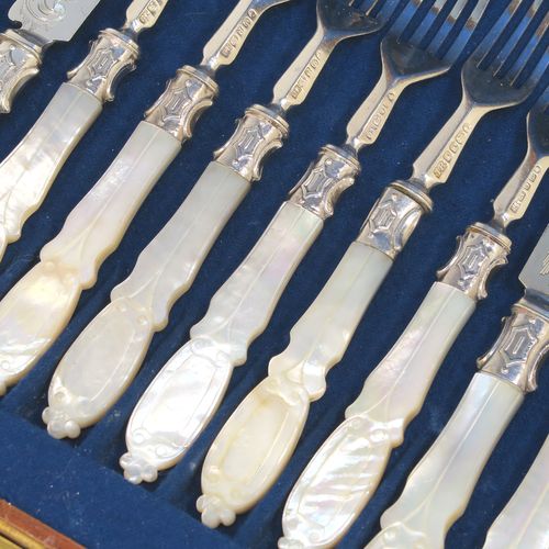 A beautiful Antique Victorian Sterling Silver and hand-carved mother-of-pearl handled fruit set for twelve people in its original dark blue velvet-lined and Walnut canteen box, with removable upper tray. The knives having slightly curved blades with silver ferrules and hand-engraved floral decoration. The forks having silver ferrules and four plain tines. This very pretty antique silver and mother-of-pearl fruit eating service was made by James Round of Sheffield over the period 1854 to 1865. The dimensions of this fine hand-made sterling silver and mother-of-pearl fruit set are length of knife 21 cms (8.25 inches), length of fork 18 cms (7 inches)   