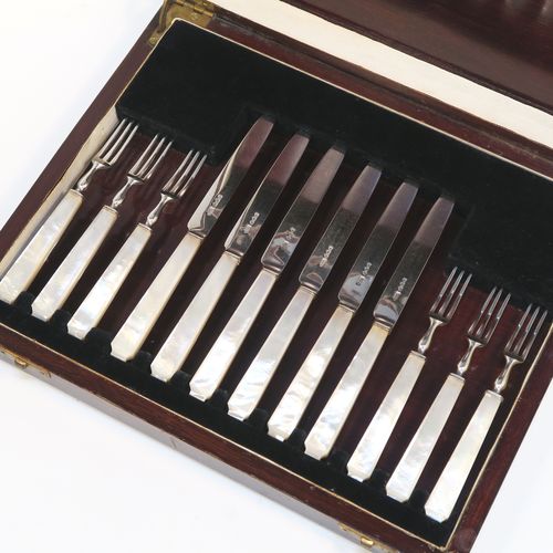 A very elegant Art Deco style Sterling Silver and mother-of-pearl handled fruit set for six people. Having plain straight-sided pointed-end blade knives, and three-prong forks. All fitted into an original wooden presentation box with black velvet-lined interior. This handsome silver fruit set was made by James Dixon and Sons of Sheffield in 1934. The dimensions of this fine hand-made silver and mother-of-pearl fruit service are length of knife 17 cms (6.75 inches), and the length of the fork 13.5 cms (5.3 inches).   