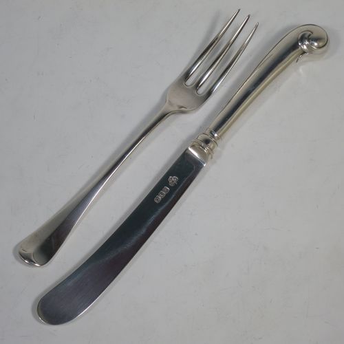 A very handsome Antique Sterling Silver fruit set for six people, in the early Hanoverian pattern, with three-prong forks and pistol-handled kives with spatular blades, all fitted into an original wooden presentation box with dark blue satin and velvet-lined interior. Made by West and Sons of London in 1916. The dimensions of this fine hand-made silver fruit service are length of knife 20.5 cms (8 inches), and the length of the fork 16.5 cms (6.5 inches).    