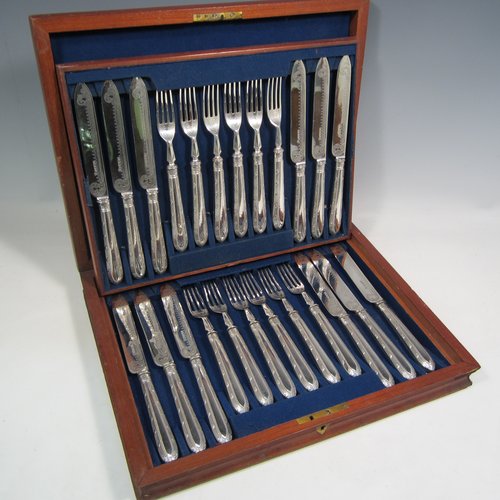 Antique Victorian sterling silver fruit set for twelve people, having hand-engraved floral decoration on the blades and four-prong forks, and the handles in a very pretty pattern with reeding and bead-work, all fitted into an original wooden presentation box with dark blue velvet interior. Made by Thomas Bradbury and Sons of Sheffield in 1883. The dimensions of this fine hand-made silver fruit service are length of knife 21.5 cms (8.5 inches), and the length of the fork 18.5 cms (7.25 inches).   