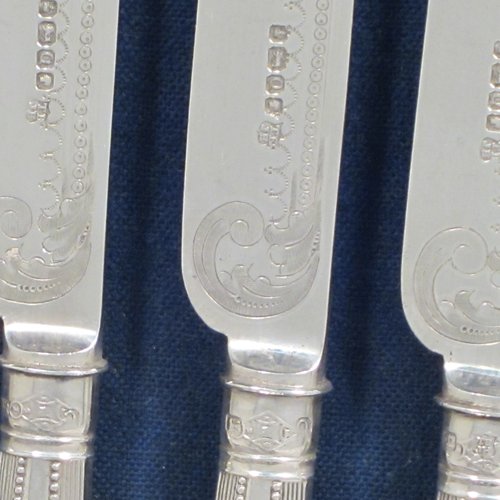 Antique Victorian sterling silver fruit set for twelve people, having hand-engraved floral decoration on the blades and four-prong forks, and the handles in a very pretty pattern with reeding and bead-work, all fitted into an original wooden presentation box with dark blue velvet interior. Made by Thomas Bradbury and Sons of Sheffield in 1883. The dimensions of this fine hand-made silver fruit service are length of knife 21.5 cms (8.5 inches), and the length of the fork 18.5 cms (7.25 inches).   