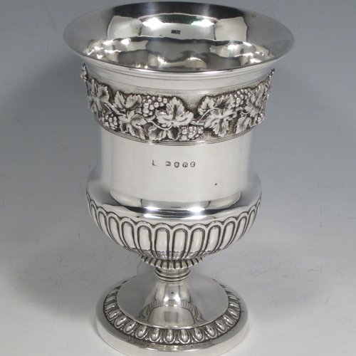 Antique Georgian sterling silver Regency goblet, having a hand-chased campagna style body, with an applied band of grapevine decoration, a half-fluted lower body, and sitting on a pedestal foot. Made in London in 1812. The dimensions of this fine hand-made silver goblet are height 15 cms (6 inches), diameter at lip 10 cms (4 inches), and it weighs approx. 386g (12.5 troy ounces).   