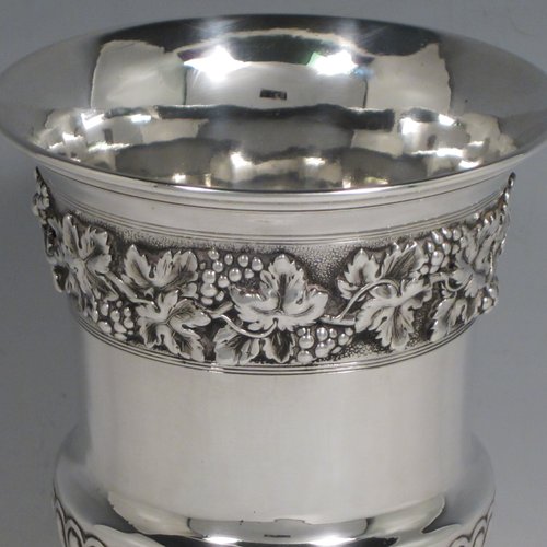 Antique Georgian sterling silver Regency goblet, having a hand-chased campagna style body, with an applied band of grapevine decoration, a half-fluted lower body, and sitting on a pedestal foot. Made in London in 1812. The dimensions of this fine hand-made silver goblet are height 15 cms (6 inches), diameter at lip 10 cms (4 inches), and it weighs approx. 386g (12.5 troy ounces).   