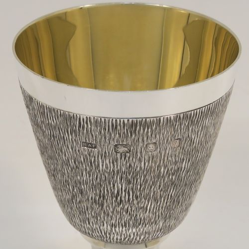 A very unusual modernistic style Sterling Silver sherry or fortified wine goblet, having a round tapering body with a hand-chased bark-like finish, a gold-gilt interior, and sitting on a plain round pedestal foot. This handsome silver sherry goblet was made by RAF of London in 1971. The dimensions of this fine hand-made silver goblet are height 11 cms (4.3 inches), diameter at lip 7.5 cms (3 inches), and it weighs approx. 164g (5.3 troy ounces).  