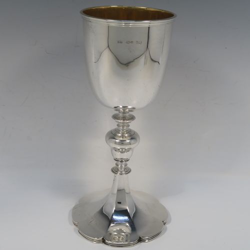 A large and handsome Antique early Victorian Sterling Silver goblet, having a plain round tapering body with a gold-gilt interior and an applied reeded top border, a stem with a round middle baluster, and sitting on a spreading panelled octofoil pedestal foot. This large and beautiful silver goblet was made by Robert Hennell III of London in 1842. The dimensions of this fine hand-made antique silver goblet are height 24.5 cms (9.75 inches), diameter at lip 10 cms (4 inches), and it weighs approx. 451g (14.5 troy ounces).  