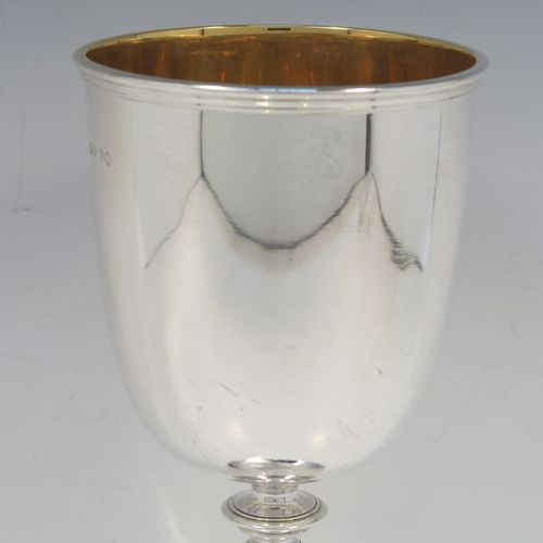 A large and handsome Antique early Victorian Sterling Silver goblet, having a plain round tapering body with a gold-gilt interior and an applied reeded top border, a stem with a round middle baluster, and sitting on a spreading panelled octofoil pedestal foot. This large and beautiful silver goblet was made by Robert Hennell III of London in 1842. The dimensions of this fine hand-made antique silver goblet are height 24.5 cms (9.75 inches), diameter at lip 10 cms (4 inches), and it weighs approx. 451g (14.5 troy ounces).  