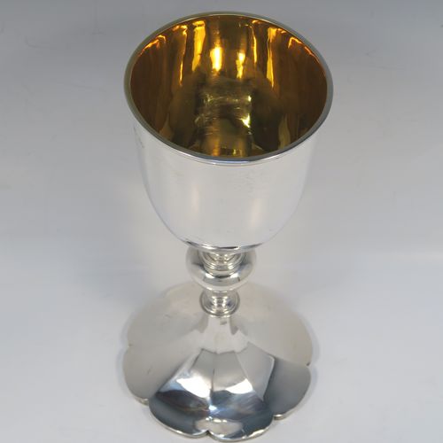 A large and handsome Antique early Victorian Sterling Silver goblet, having a plain round tapering body with a gold-gilt interior and an applied reeded top border, a stem with a round middle baluster, and sitting on a spreading panelled octofoil pedestal foot. This large and beautiful silver goblet was made by Robert Hennell III of London in 1842. The dimensions of this fine hand-made antique silver goblet are height 24.5 cms (9.75 inches), diameter at lip 10 cms (4 inches), and it weighs approx. 451g (14.5 troy ounces).  