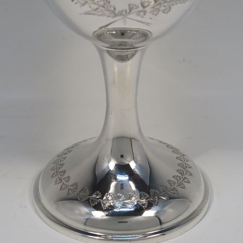 A very pretty Antique Edwardian Sterling Silver goblet, having a round bellied body with hand-engraved floral and gingko leaf decoration, a gold-gilt interior, and sitting on a pedestal foot with matching decoration. This beautiful silver goblet was made by Joseph Gloster of Birmingham in 1906. The dimensions of this fine hand-made antique silver goblet are height 18 cms (7 inches), diameter at lip 9.5 cms (3.75 inches), and it weighs approx. 245g (7.9 troy ounces). Please note that this item has a contemporaneous inscription.