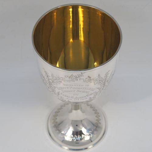 A very pretty Antique Edwardian Sterling Silver goblet, having a round bellied body with hand-engraved floral and gingko leaf decoration, a gold-gilt interior, and sitting on a pedestal foot with matching decoration. This beautiful silver goblet was made by Joseph Gloster of Birmingham in 1906. The dimensions of this fine hand-made antique silver goblet are height 18 cms (7 inches), diameter at lip 9.5 cms (3.75 inches), and it weighs approx. 245g (7.9 troy ounces). Please note that this item has a contemporaneous inscription.