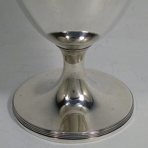 A very handsome pair of Antique Georgian Sterling Silver goblets, having plain round bodies with tapering sides, and sitting on pedestal feet with reeded borders. Made by John Robins of London in 1800. The dimensions of this fine hand-made pair of antique silver goblets are height 12 cms (4.75 inches), diameter at top 8 cms (3 inches), and the total weight is approx. 384g (12.4 troy ounces).   